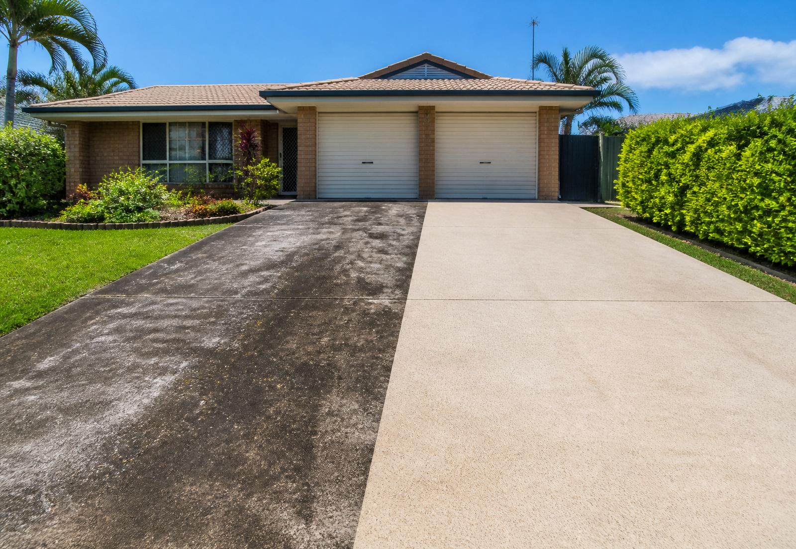 Half-cleaned driveway showing dramatic pressure washing results in Ipswich